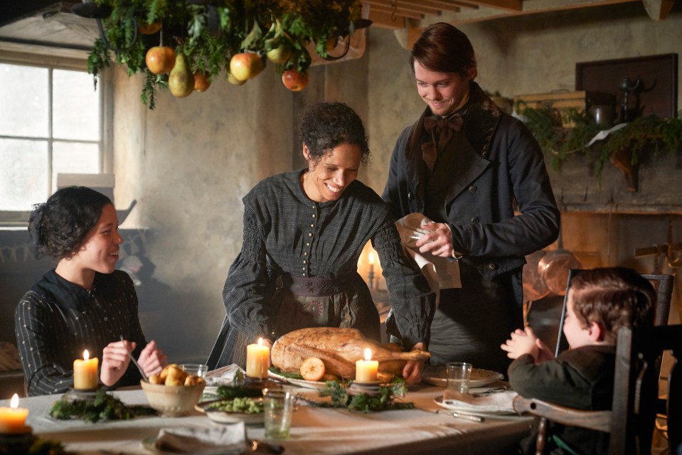 a group of people sitting around a table with a turkey on it