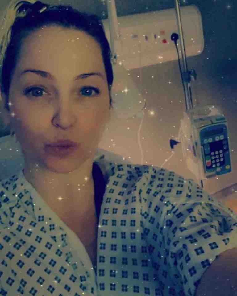 a woman in a hospital gown stands in front of an infusion machine