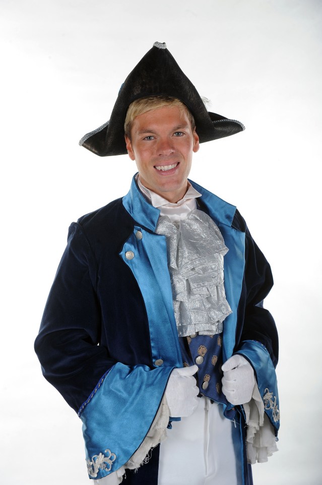 Man in a blue and dark blue theatrical costume.
