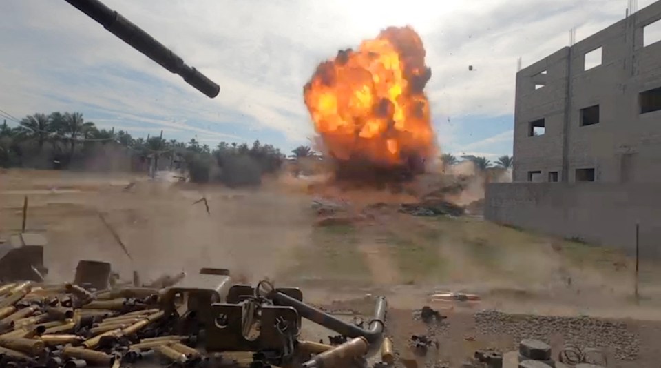 Debris scatters after an explosion during what the Israeli army says was an operation in Khan Younis, where Sinwar is believed to be hiding