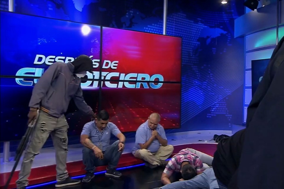 Masked gang members stormed a TV station armed with guns and bombs during live broadcast