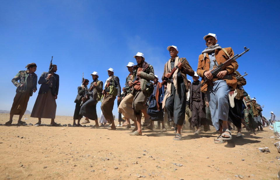 Newly recruited members of the Houthis marched with weapons in hand