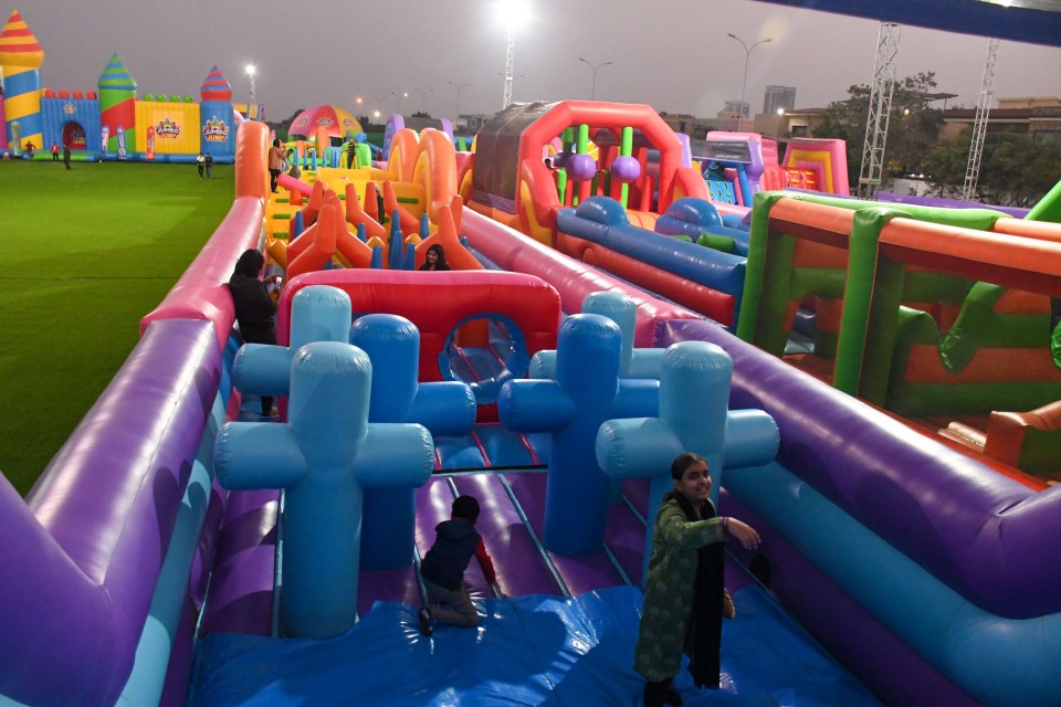 Pictures show adults and children alike leaping, climbing, and sliding on several of the park's fun zones.