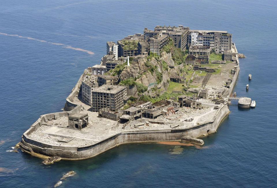 Aerial view of Hashima Island, also known as Battleship Island, showing the ruins of its buildings and infrastructure.