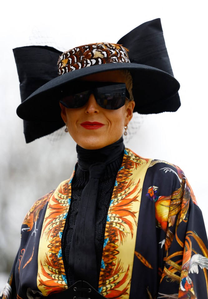 One guest looked chic in sunglasses and a bow-adorned hat for her Cheltenham look