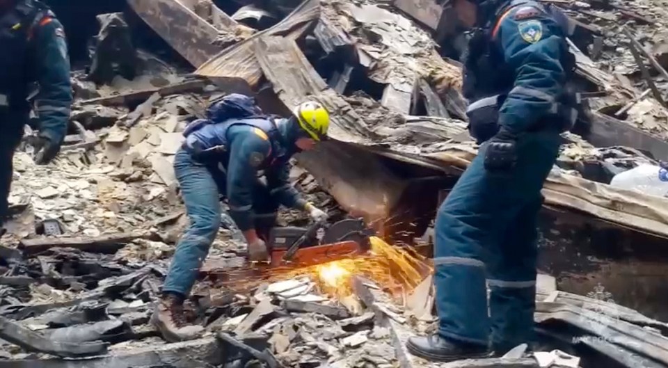 Rescuers work in the burned concert hall after a terrorists attack on the building of the Crocus City Hall