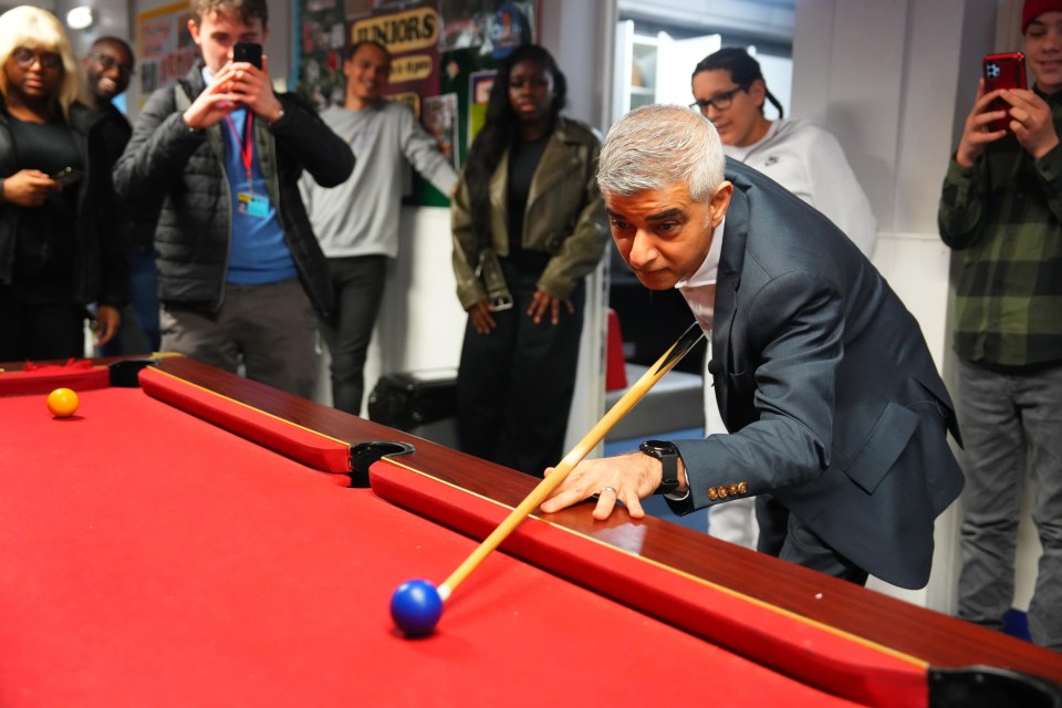 LONDON, ENGLAND - MARCH 21: London Mayor Sadiq Khan plays pool during a visit to the Knights Youth Centre on March 21, 2024 in London, England. Sadiq Khan's visit was part of a youth services announcement for his re-election campaign as Mayor. The election will be held on 2 May 2024, simultaneously with elections to the London Assembly and local elections. (Photo by Carl Court/Getty Images)