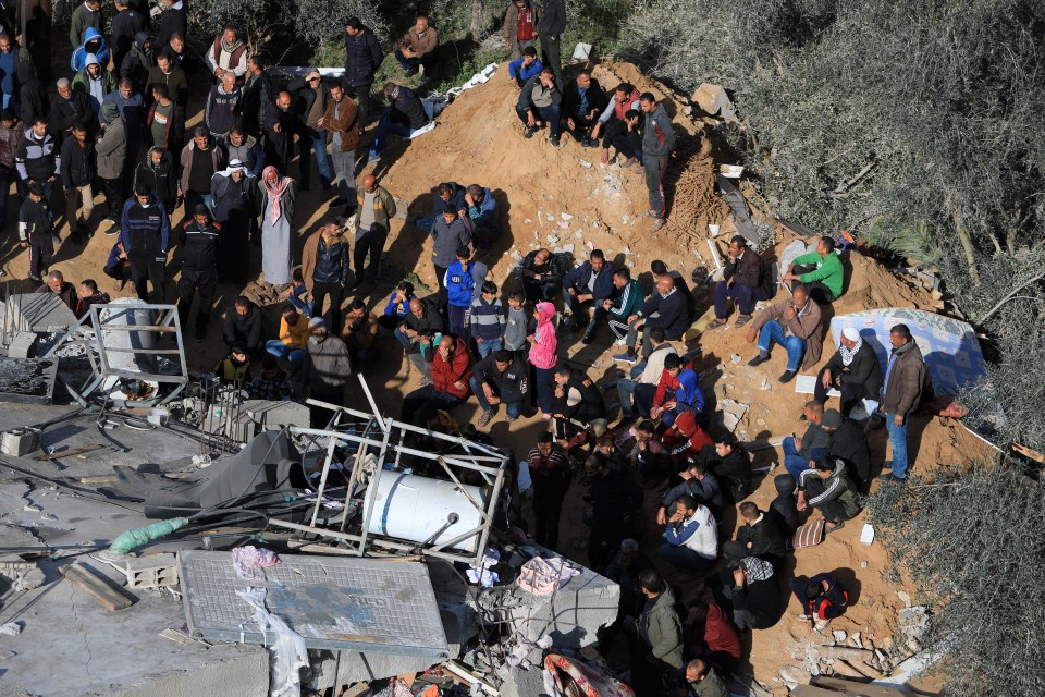 Palestinians carry out search and rescue operations among the rubble after an Israeli attack wrecks a building in Rafah on March 4