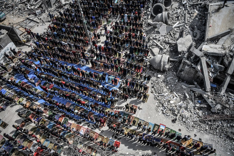 Palestinians perform Friday prayers among the rubble of the Al-Farooq Mosque, destroyed in an Israeli attack, in Rafah on March 1