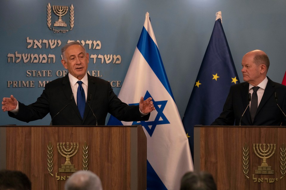 Netanyahu, left, delivers his speech after meeting with German Chancellor Olaf Scholz