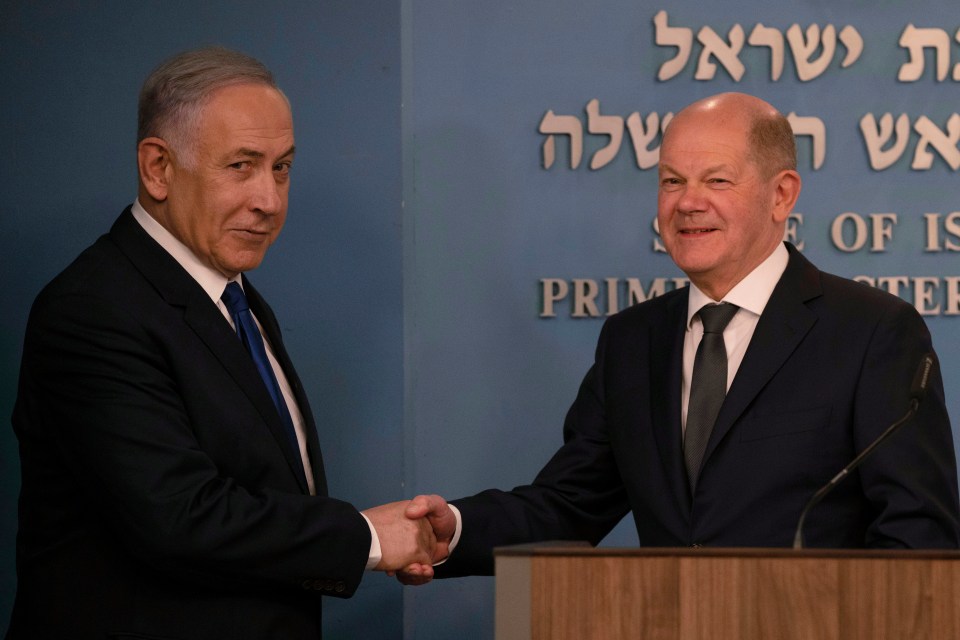 The Israeli PM and Scholz shake hands after delivering their speeches