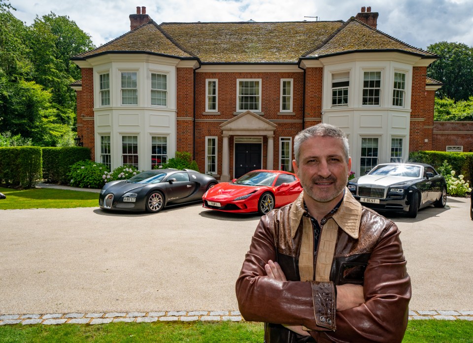 Self-made millionaire Alfie Best standing in front of his home with three luxury cars.