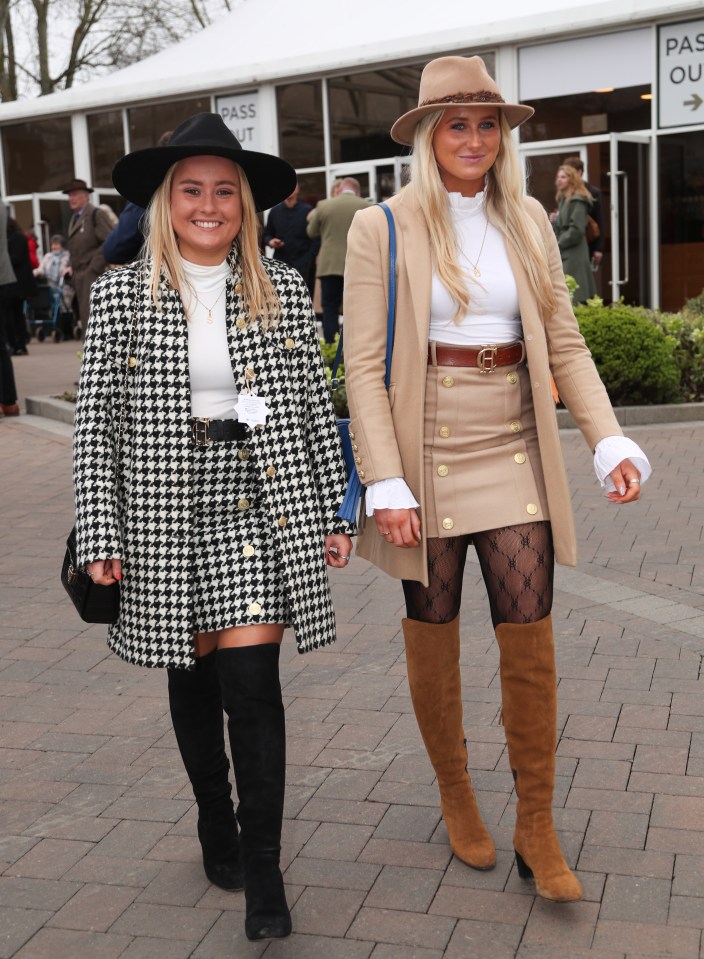 Two pals in boots, mini skirts and long coats were all smiles for the celebrations that used to be Ladies Day
