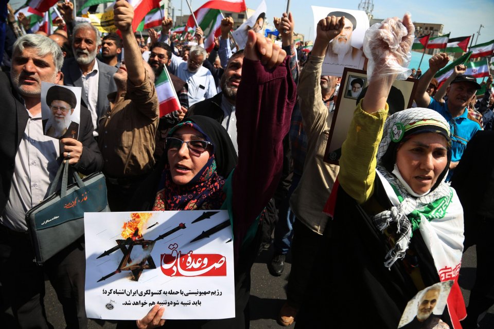Iranians carrying more placards and chanting slogans during Friday's anti-Israel rally in Tehran