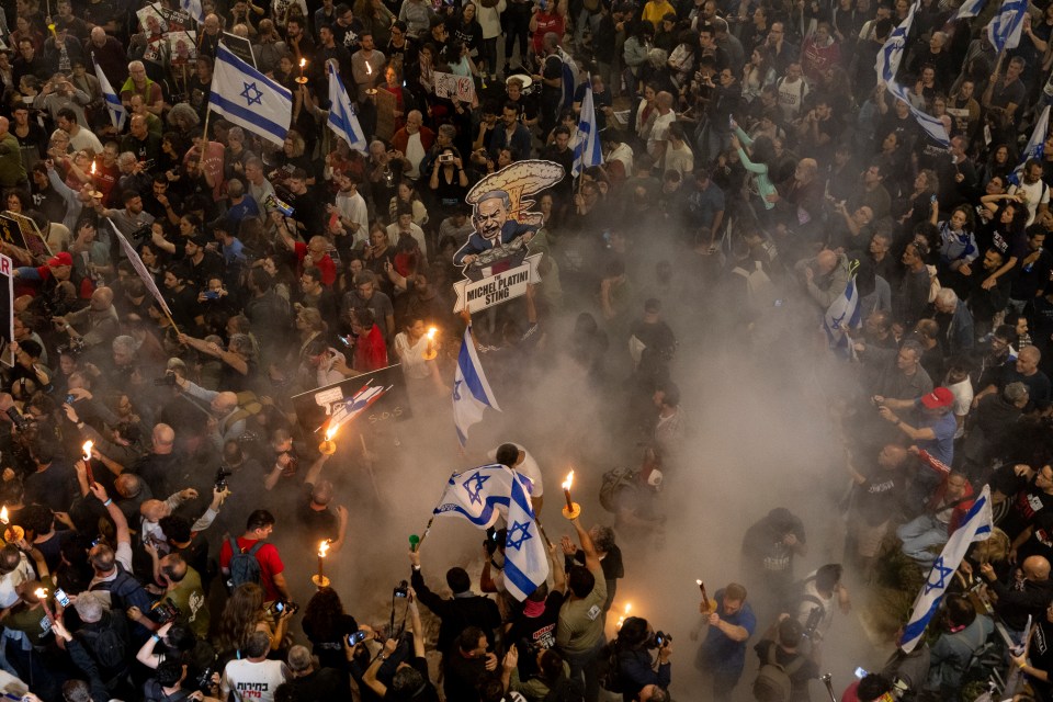 TEL AVIV, ISRAEL - APRIL 6: Protesters light a fire and hold flame torches during a demonstration calling for a hostages deal and against the Israeli government on April 6, 2024 in Tel Aviv, Israel. Israeli officials visited Egypt earlier this week as part of ongoing ceasefire negotiations, but the country and Hamas seem to remain at an impasse over the proposed duration of any ceasefire, among other conditions.(Photo by Amir Levy/Getty Images)