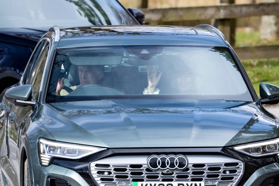 King Charles gives a wave to well-wishers as he drives to church with Queen Camilla