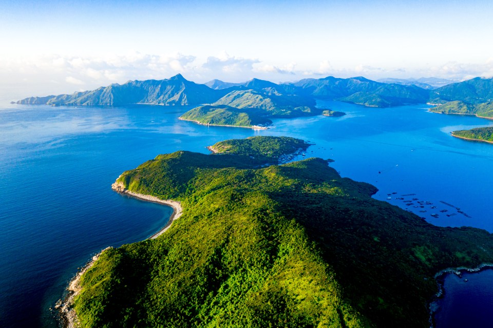 a large body of water with mountains in the background