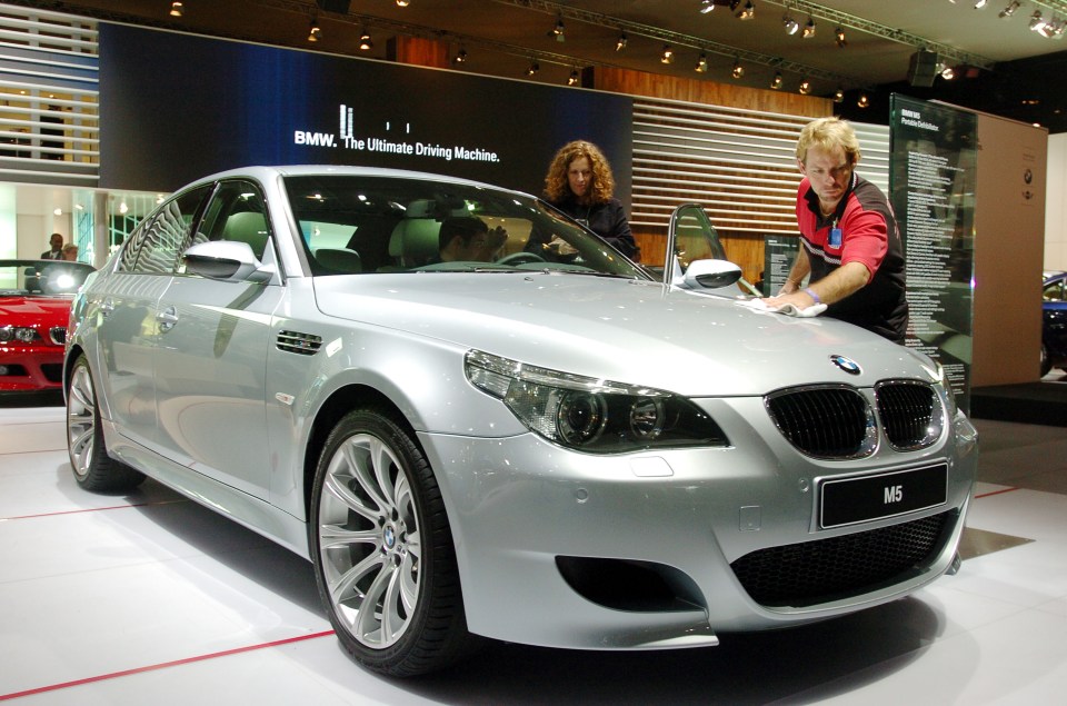 DETROIT, MI - JANUARY 10:  Bill Nelson of Waycross, Georgia polishes a BMW M5 after a press conference January 10, 2005 at the North American International Auto Show in Detroit, Michigan. Nelson works for BMW as a professional detailer.  (Photo by Bryan Mitchell/Getty Images)
