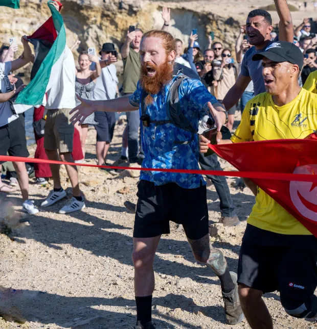 The moment Cook crossed the finishing line in Tunisia on Sunday after 352 days