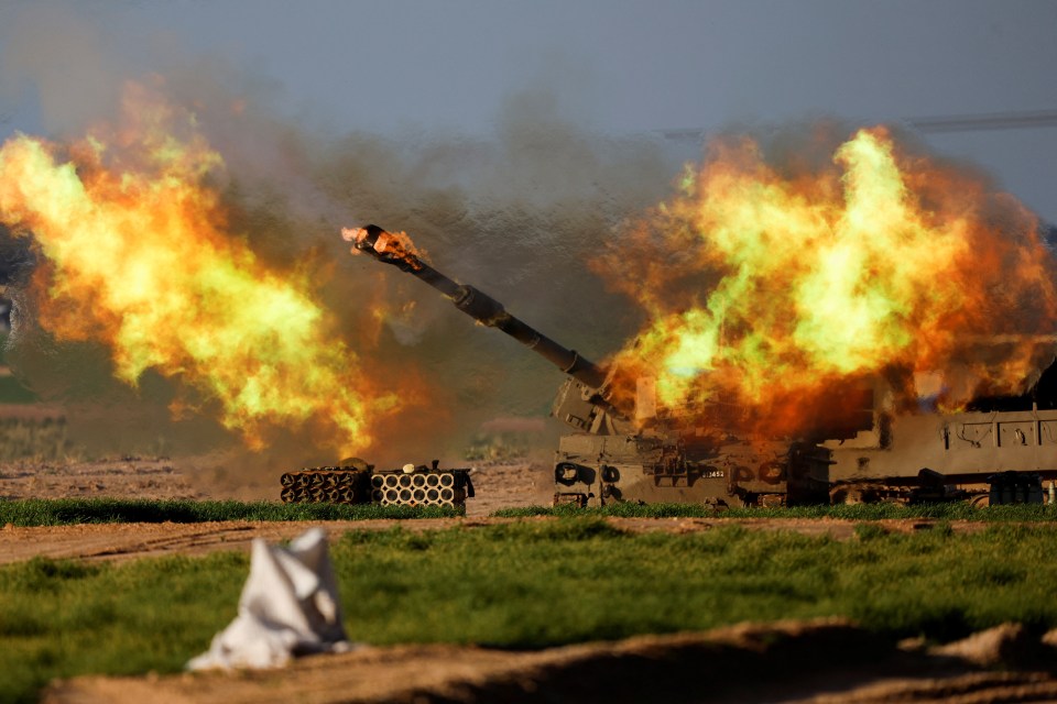 An Israeli mobile artillery unit fires towards Gaza