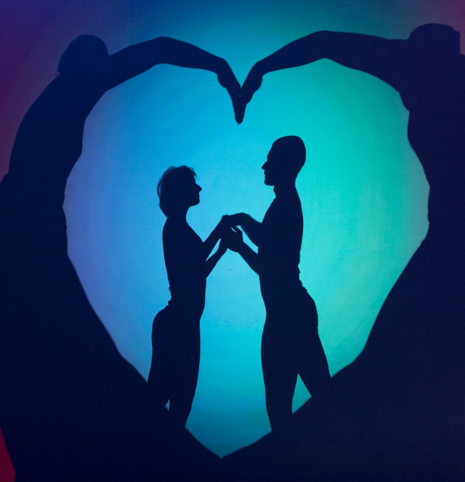 Silhouette of a couple holding hands, framed by a heart-shaped shadow.