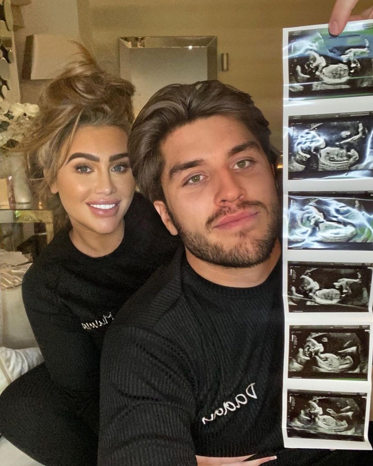 Couple holding baby scan photos.