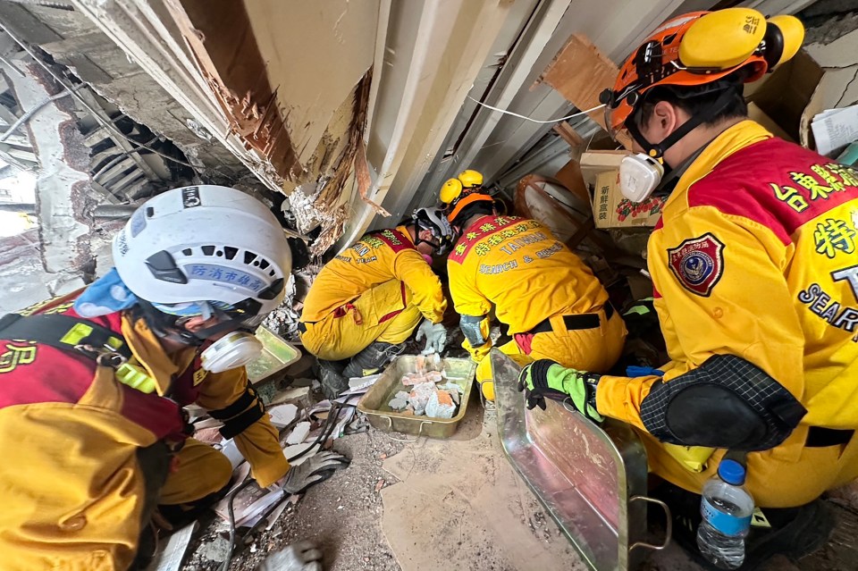 Members of a rescue team search for survivors in a damaged building in Hualien