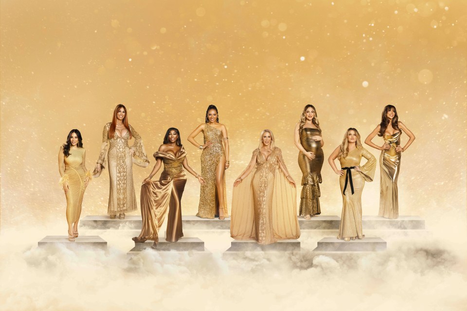 a group of women in gold dresses are standing on steps