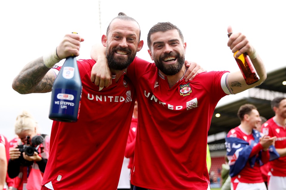 Wrexham players Steven Fletcher and Elliott Lee celebrating promotion to League One.