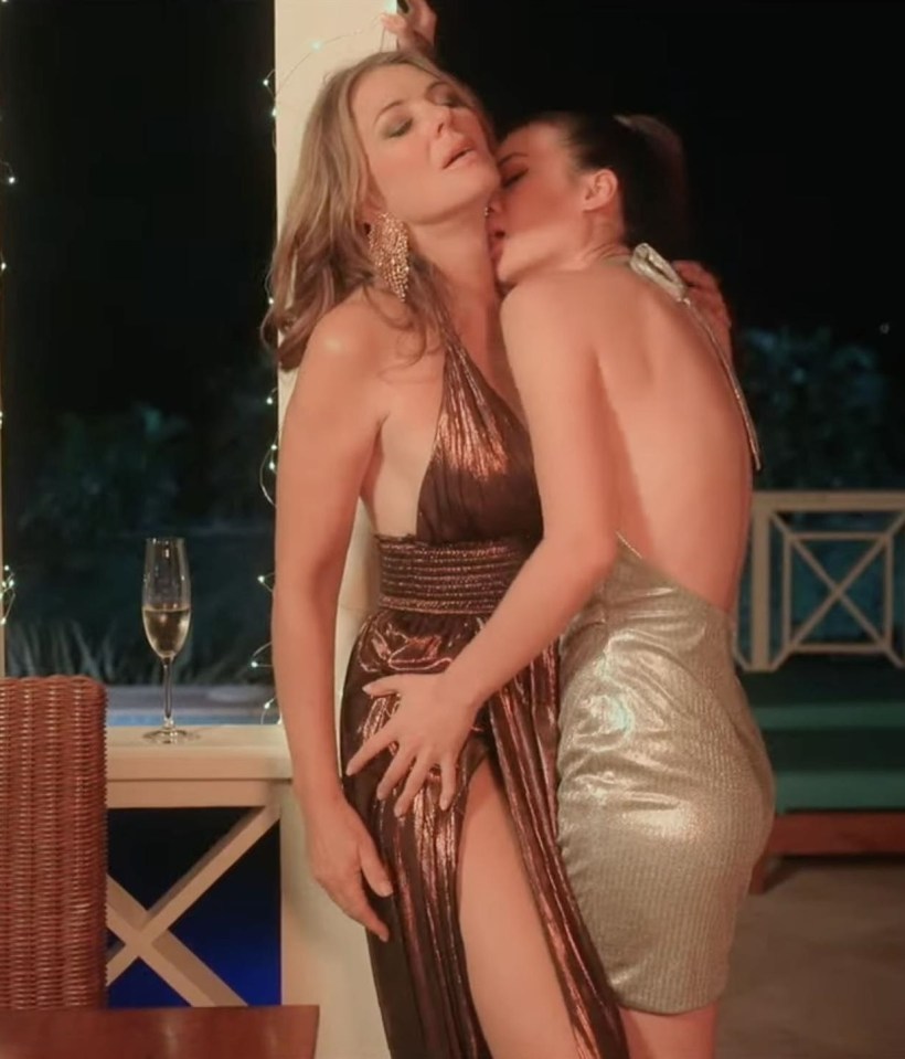 Still image from the film *Strictly Confidential* showing Elizabeth Hurley and Pear Chiravara in a lesbian sex scene.
