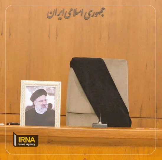 The chair where President Raisi sat during government meetings is wrapped with black cloth during an urgent meeting of government on Monday