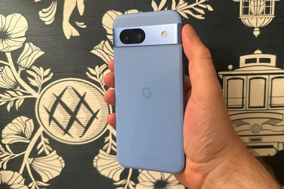 a person is holding a light blue google phone