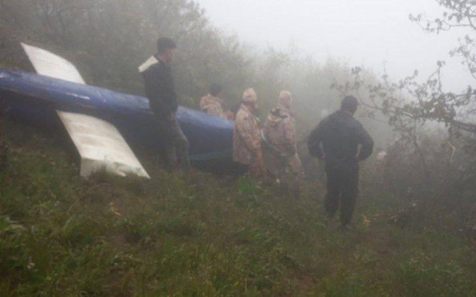 Search and rescue personnel survey the site of the helicopter crash