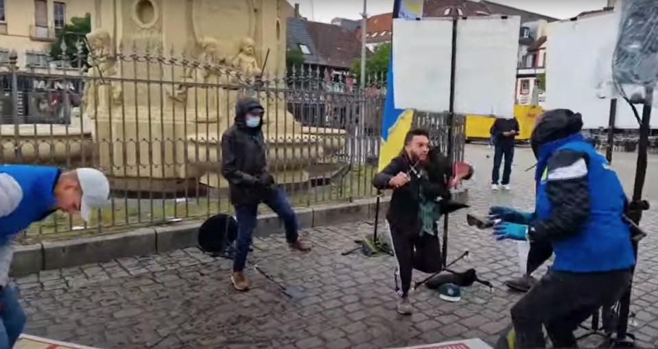 One of at least three victims appears terrified as he backs away from the attacker