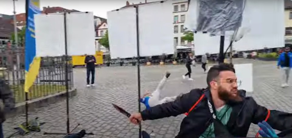 The knifeman launches at a man who had reportedly taken part in an anti-Islam rally