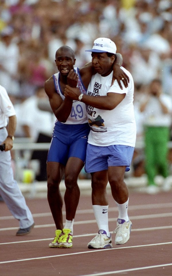 Aug 1992: Derek Redmond of Great Britain is helped towards the finish line by his father Jim Redmond after suffering an injury in the 400m semi-final at the Barcelona Olympic Games in Spain. \\ Mandatory Credit: Gray Mortimore /Allsport