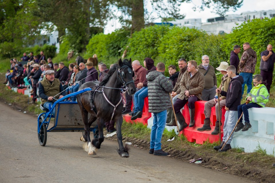 Travellers race their horses and traps along the ‘Flashing Lane’ during the Appleby Horse Fair on Saturday