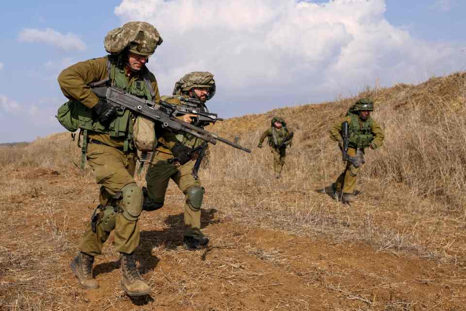 a group of soldiers are walking through a field