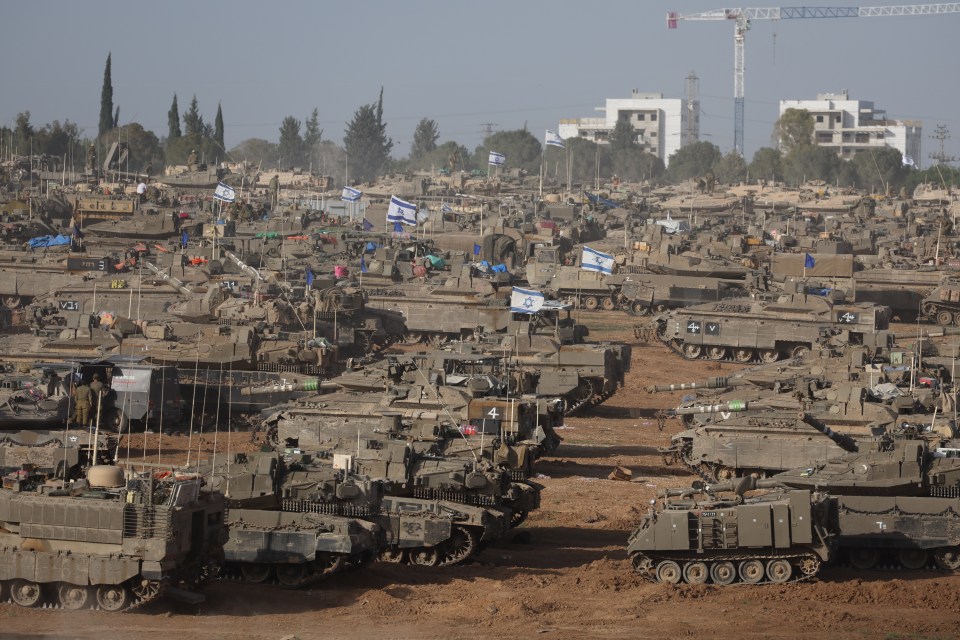 Israeli military vehicles mass at the border with the Gaza Strip