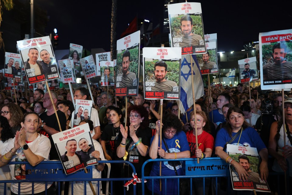 a crowd of people holding signs that say bring him home now