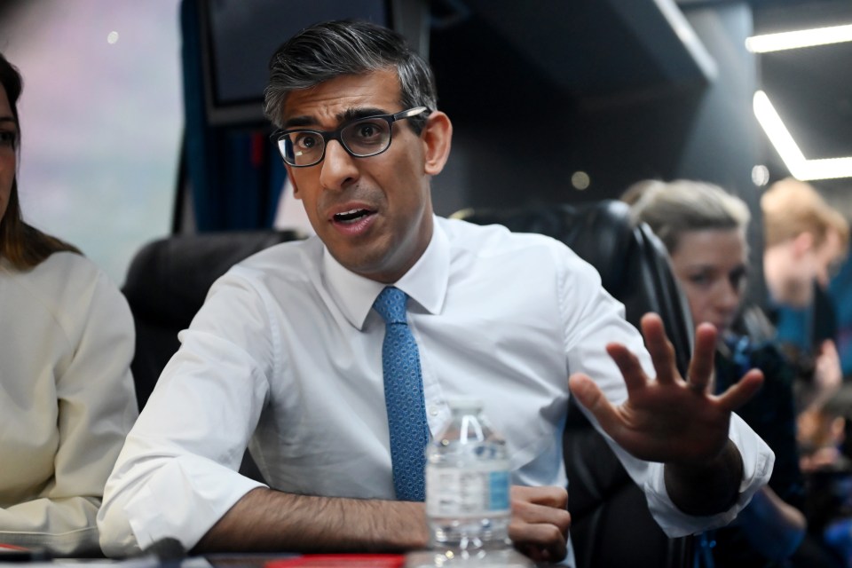 a man in a white shirt and blue tie holds a bottle of water