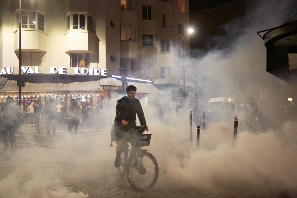 a man riding a bike in front of a building that says au val de loire