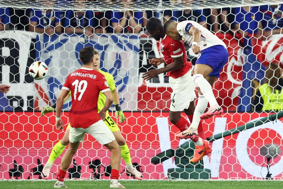 France's forward #10 Kylian Mbappe collides with Austria's defender #04 Kevin Danso (L) during the UEFA Euro 2024 Group D football match between Austria and France at the Duesseldorf Arena in Duesseldorf on June 17, 2024. (Photo by FRANCK FIFE / AFP) (Photo by FRANCK FIFE/AFP via Getty Images)