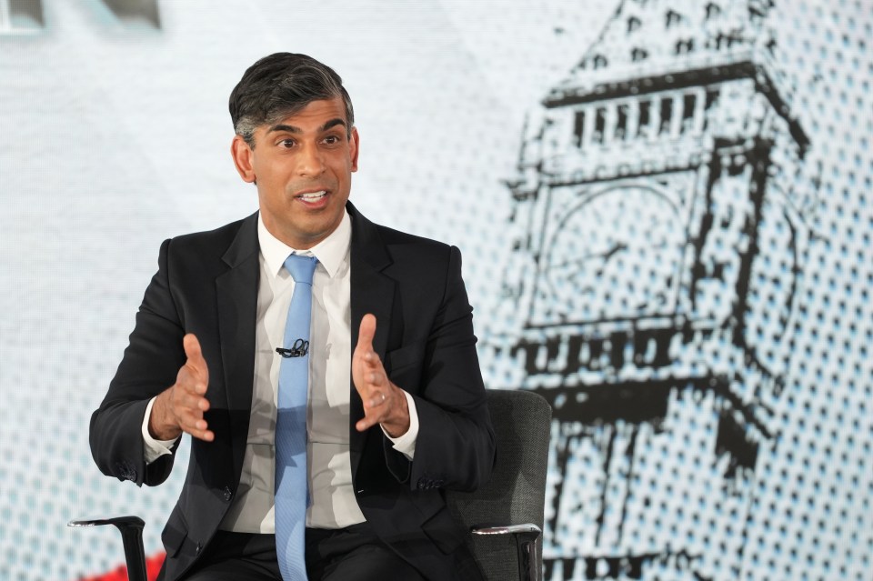 a man in a suit and tie is sitting in front of a big ben clock tower