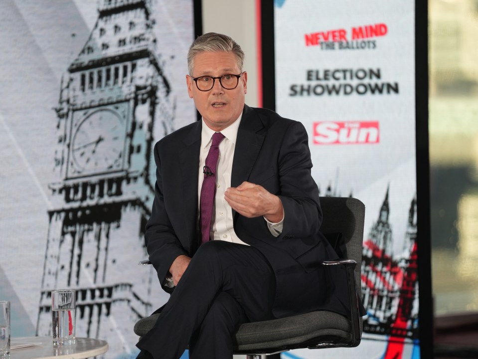a man sitting in front of a sign that says election showdown