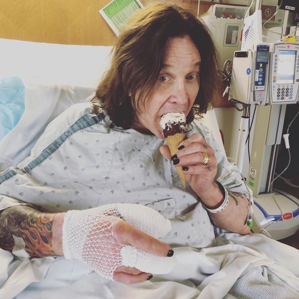 Ozzy Osbourne in a hospital bed eating ice cream, his hand bandaged.