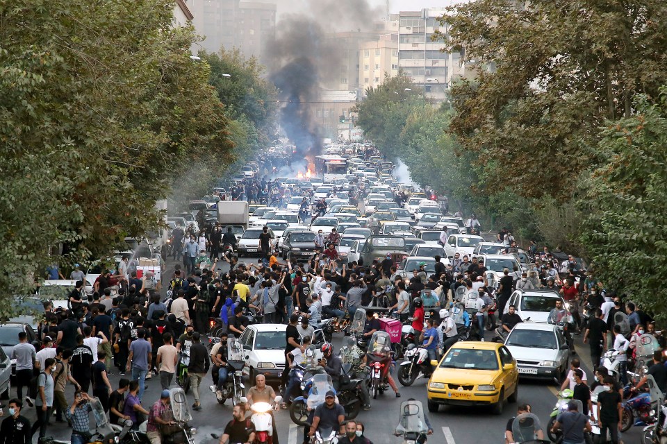 a crowd of people are gathered on a busy street