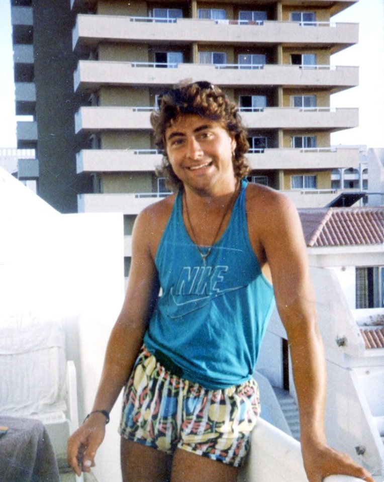 a man wearing a blue nike tank top and shorts