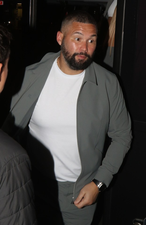 a man with a beard is wearing a white shirt and a grey jacket
