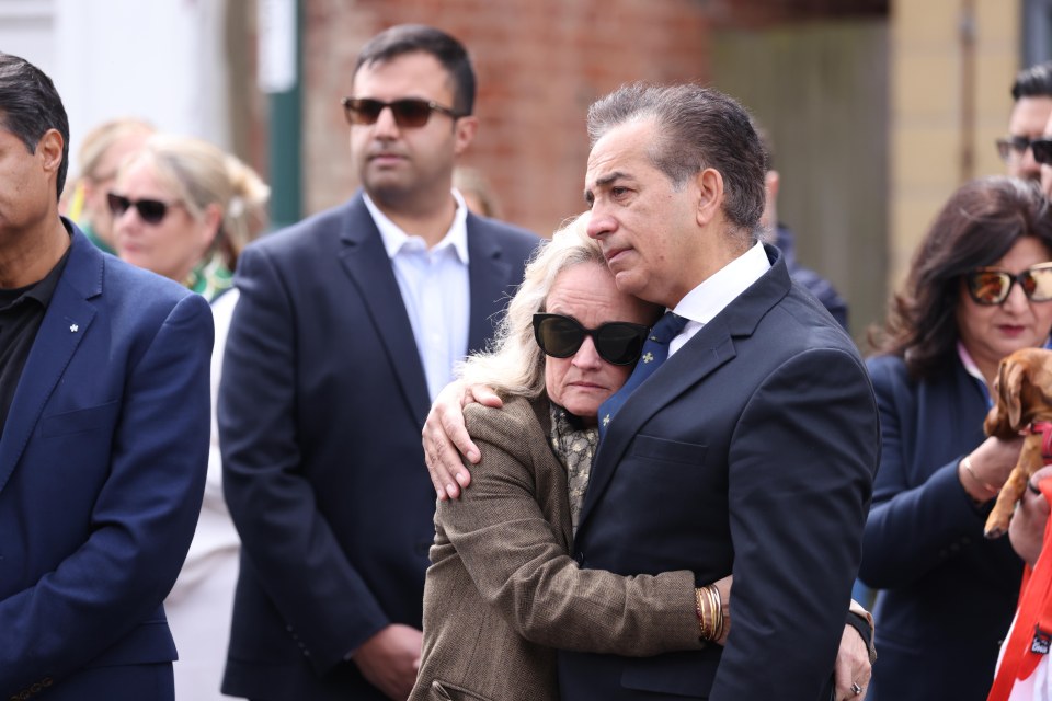 Grace's parents appeared tearful as they watched her fellow students lay flowers in her memory